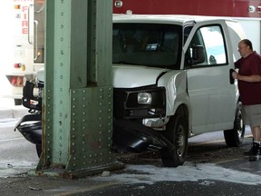 A van hit a support column under the train viaduct at Wyandotte Street East and Drouillard Road in Windsor, Ont., on Tuesday, May 7, 2013. The van and two other vehicles collided. No one was seriously injured in the accident. (TYLER BROWNBRIDGE/The Windsor Star)