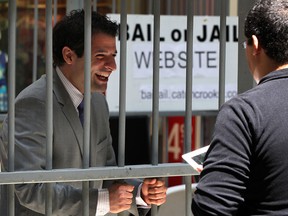 Fred Francis, left, of Rafih Auto Group pleads his case from behind bars during the annual Bail or Jail fundraiser for Windsor and Essex County Crime Stoppers at Devonshire Mall Friday May 17, 2013. (NICK BRANCACCIO/The Windsor Star)