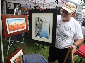 Wildlife artist Marc De Groote sets up part of his display at annual Art in the Park at Willistead Park Friday June 4, 2010. A retired landscaper, De Groote is one of 25 top wildlife artists from Canada who have been invited to the Wild Fowl Habitat Canada competition. (NICK BRANCACCIO/ The Windsor Star)