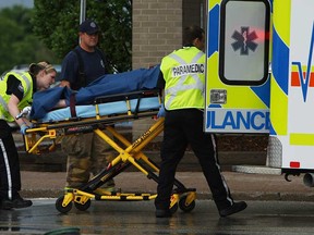 A pedestrian is loaded into a waiting ambulance after an adult and a child were struck by a car near the Sears store at Devonshire Mall in Windsor on Thursday, May 30, 2013. Both were transported to hospital with non-life threatening injuries.         (TYLER BROWNBRIDGE/The Windsor Star)