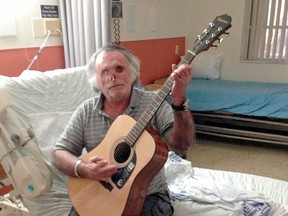 In this undated photo provided by Jackson Health System, Ronald Poppo, a homeless man whose face was mostly chewed off in a bizarre attack last year in Miami, plays the guitar in his room at Jackson Memorial Perdue Medical Center in Cutler Bay, Fla. The attack left Poppo blind, but doctors say he's been working with an occupational therapist to learn how to take care of himself. The doctors say Poppo also has learned to play guitar and practices daily. (AP Photo/Jackson Health System)