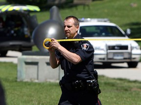 Windsor police close off a section of the riverfront to recover a body from the Detroit River in Windsor on Friday, May 24, 2013. A body was discovered by a passerby around 2:30 p.m. Police are investigating. (TYLER BROWNBRIDGE/The Windsor Star)