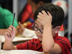 Dougall Public School student Kyle O'Keefe, 6, works on a task Wednesday, May 8, 2013, in Windsor, Ont. (DAN JANISSE/The Windsor Star)