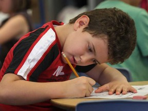 Dougall Public School student Arlind Avdo, 6, works on a task Wednesday, May 8, 2013, in Windsor, Ont. (DAN JANISSE/The Windsor Star)