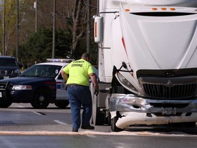 County Towing operator prepares to tow an International tractor following a collision with a Chevy Equinox on Front Road Thursday May 2, 2013. Crash witness Mike May pulled over in a separate vehicle when a large snapping turtle slowly tried to cross the roadway.  The Equinox stopped for the turtle and was hit by the truck, according to May. Amherstburg Police and firefighters were at the scene. (NICK BRANCACCIO/The Windsor Star)