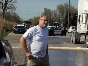 Motorist Mike May stands on Front Road after witnessing a collision involving a Chevy Equinox and an International tractor Thursday May 2, 2013. May pulled over when a large snapping turtle slowly tried to cross the busy roadway.  When the Equinox stopped for the turtle, it was hit by the truck, according to May. Amherstburg Police and firefighters were at the scene. (NICK BRANCACCIO/The Windsor Star)
