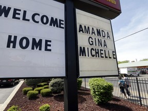 FILE - In this Thursday, May 9, 2013 file photo, a "Welcome Home" sign is posted at a restaurant near a crime scene where three women were held captive for a decade in Cleveland. For Gina DeJesus, Amanda Berry and Michelle Knight, who were freed from captivity inside a Cleveland house Monday, May 6, 2013, the ordeal is not over. Next comes recovery _ from sexual abuse and their sudden, jarring reentry into a world much different than the one they were snatched from a decade ago. (AP Photo/David Duprey, File)