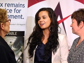 Premier Kathleen Wynne, left,  and Windsor West MPP Teresa Piruzza speak on Wednesday, May 22, 2013, with Nour Hachem following the announcement of an Ontario Trillium Foundation grant of $100,000 toward the WE Explore Project which helps young business leaders make the connection to the workplace. (NICK BRANCACCIO/The Windsor Star)