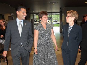 Ontario Premier Kathleen Wynne, right, walks with MPP Teresa Piruzza and Windsor Mayor Eddie Francis, Wednesday, May 22, 2013, at the 400 building at city hall in Windsor, Ont. (DAN JANISSE/The Windsor Star)