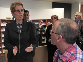 Ontario Premier Kathleen Wynne chats with Dan Clark, a client at the City of Windsor's Employment and Training Services office Wednesday, May 22, 2013, in Windsor, Ont. (DAN JANISSE/The Windsor Star)