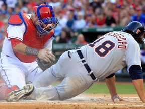Texas catcher Geovany Soto, left, tags out Detroit's Matt Tuiasosopo at home plate during the second inning Sunday in Arlington. (AP Photo/John F. Rhodes)