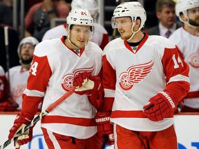 Detroit's Gustav Nyquist, right, smiles as he talks with Damien Brunner during the second period of Game 2 against the Chicago Blackhawks in Chicago Saturday. (AP Photo/Nam Y. Huh)
