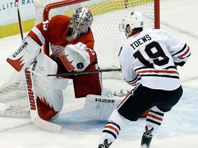 Detroit goalie Jimmy Howard, left, makes a save on Chicago's Jonathan Toews in Game 4 of the Western Conference semifinal. (AP Photo/Paul Sancya)
