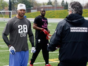 Former AKO players Daryl Townsend, left, and Michael Carter, behind,  work out for Craig Smith, director of player personel for the Saskatchewan Roughriders, in 2011. (NICK BRANCACCIO/The Windsor Star)