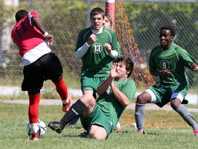 Forster's Ali Mohamed Abdullah, left, draws several defenders as Daniel Bietoia, left, Aiden Johnson-Bujold and Joel Kabula of Lajeunesse try to block the shot in the high school soccer final at Forster. (NICK BRANCACCIO/The Windsor Star)