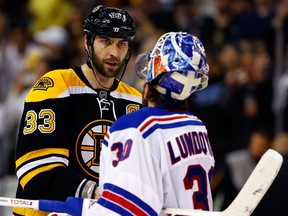 Boston's Zdeno Chara, left, shakes hands with New York goalie Henrik Lundqvist at the end of Game 5 Saturday. (Photo by Jared Wickerham/Getty Images)