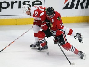 Chicago's Jonathan Toews, right, battles Detroit's Johan Franzen in Game 5 of the Western Conference semifinal Saturday. (Photo by Jonathan Daniel/Getty Images)