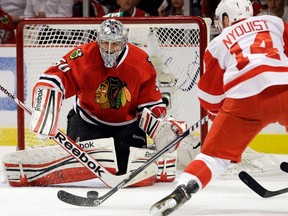 Chicago goalie Corey Crawford, left, makes a save on Detroit's Gustav Nyquist Saturday. (AP Photo/Nam Y. Huh)