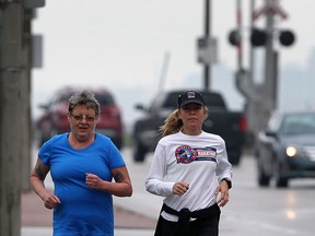 Deb Steedman runs with Kelly Steele along Riverside Drive East Monday April 29, 2013.  Steedman is headed to Tilbury and eventually, Ottawa, bringing awareness to Mental Health issues. (NICK BRANCACCIO/The Windsor Star)