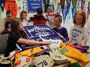 Ruthven Public School students Judy Guenther, left, Corny Janzen, Adam Bergen, Jaxon Klassen, Judy DiVincenzo, Ricky Neufeld and Krystal Robinson, right, sort through dozens of school banners, many of which are displayed in the school's hallways Wednesday May 29, 2013. Ruthven Public School is scheduled to close.  (NICK BRANCACCIO/The Windsor Star)