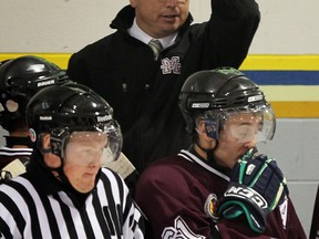 Ex-Spit Bill Bowler shields himself from a puck behind the Chatham bench. (NICK BRANCACCIO/The Windsor Star)