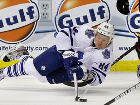 Toronto's Mikhail Grabovski tries to control the puck against the Boston Bruins Wednesday. (AP Photo/Elise Amendola)