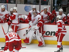 Wings goalie Jimmy Howard, centre, and his teammates react after losing 2-1 in overtime against the Chicago Blackhawks in Game 7 Wednesday. (Photo by Jonathan Daniel/Getty Images)