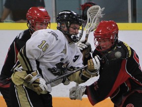Windsor's Brendan Anger, centre, is surrounded by two Wallaceburg players in junior B lacrosse Wednesday. (JASON KRYK/The Windsor Star)
