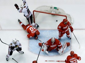 Chicago's Marian Hossa, bottom left, scores a goal against Detroit goalie Jimmy Howard in Game 6 in Detroit Monday. (AP Photo/Paul Sancya)