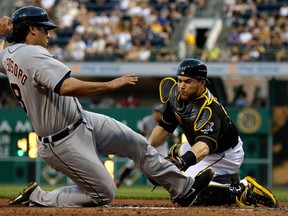 Pittsburgh catcher Russell Martin, right, tags out Detroit's Matt Tuiasosopo during the fifth inning in Pittsburgh Thursday. (AP Photo/Gene J. Puskar)