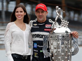 IndyCar driver Tony Kanaan, right, poses with his wife Lauren next to the Borg Warner Trophy at the yard of bricks during the Indianapolis 500 Mile Race Trophy Presentation and Champions Portrait Session at Indianapolis Motor Speedway Saturday in Indianapolis. (Photo by Chris Graythen/Getty Images)
