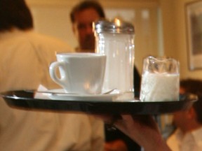 A server brings cream and sugar to a table. (Windsor Star files)