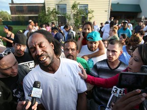 Neighbor Charles Ramsey speaks to media near the home on the 2200 block of Seymour Avenue, where three missing women were rescued in Cleveland, on Monday, May 6, 2013. (AP Photo/The Plain Dealer, Scott Shaw)