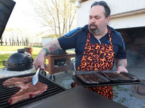 BBQ Chef Jules Mailloux cooks a steak at his Stoney Point home. (DAN JANISSE/The Windsor Star)