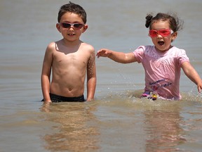 Evan (L) and Emma-Lee Gonzalez enjoy the water at Sandpoint Beach in this 2011 file photo. (Dax Melmer / The Windsor Star)