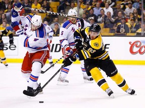 Boston's Brad Marchand, right, carries the puck around New York's Michael Del Zotto in Game 1 of the Eastern Conference Semifinals May 16, 2013 at TD Garden in Boston. (Jared Wickerham/Getty Images)