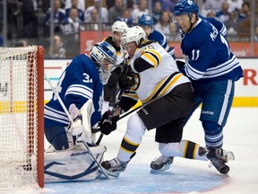 Maple Leafs goaltender James Reimer, left, makes a diving save on Boston's Tyler Seguin, centre, as Toronto's Jay McClement defends during first-round playoff action in Toronto Wednesday May 8, 2013. (THE CANADIAN PRESS/Frank Gunn)