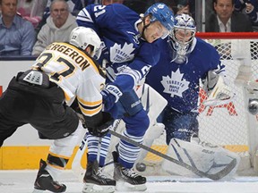 Toronto's James van Riemsdyk, centre, clears the puck away for goalie James Reimer against Boston's Patrice Bergeron during Game 4 of the Eastern Conference Quarter-finals May 8, 2013 at the Air Canada Centre in Toronto. (Claus Andersen/Getty Images)