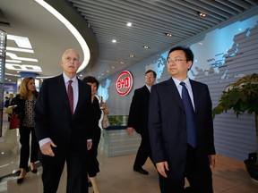 Jerry Brown, the governor of California (L), and Wang Chuanfu, founder and chairman of BYD, tour the company's headquarters in Shenzhen, China, on April 16, 2013. (Vincent Yu / Associated Press)