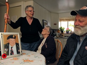 Files: Pat Major, middle, sits in her home with Andrea Grimes, left, and neigbour Glenn Woodrich, right, in Windsor, Ont., Saturday March 12, 2011.  Major has just received her late husband's cane that went missing the day he passed, from her neighbour Glenn Woodrich, 65, who wasn't aware anyone was looking for it or who it belonged to.  (DAX MELMER / The Windsor Star)