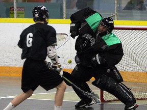 Windsor's Austin Thompson, left, fires a shot at Clippers goaltender Kyle May during practice at Forest Glade Arena. The Clippers won their season opener Saturday against Guelph but lost to Six Nations Sunday. (TYLER BROWNBRIDGE/The Windsor Star)