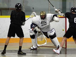 Windsor Clipper Jarrod Riley, left, fires a shot at goaltender Cooper Cecile, centre, as Austin Thompson looks on during a team practice at Forest Glade Arena. The Clippers host Brampton Saturday. (TYLER BROWNBRIDGE/The Windsor Star)