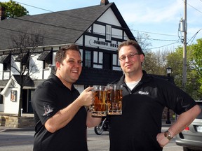 Chris Mickle (L) and Kristian Neill (R), current owners and operators of the Dominion House, hoist their mugs in honour of their bar - reputedly the second oldest tavern in Ontario. Photographed in Windsor, Ont. on May 7, 2013. (Nick Brancaccio / The Windsor Star)