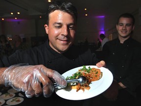 Jeff White, owner of Just Jeff's Gourmet Express,  serves up jerk chicken with apple coleslaw during the 2013 Big Brothers Big Sisters of Windsor Essex Battle of the Hors D'oeuvres held at the St. Clair Centre for the Arts in Windsor, Ontario on May 23, 2013. The fundraising event hosted food stations from area restaurants serving some of the finest hors d'oeuvres available.  Winery and brewery displays were also available for guests to visit.  (JASON KRYK/The Windsor Star)