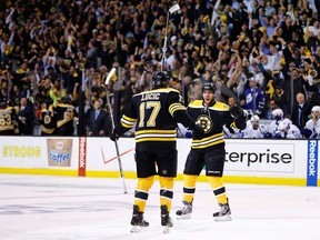 Boston's Matt Bartkowski, right, celebrates with teammate Milan Lucic after scoring a goal against Toronto in Game 7 of the Eastern Conference Quarter-finals May 13, 2013 at TD Garden in Boston. (Jared Wickerham/Getty Images)