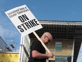 A striking member of the International Union of Elevator Constructors pickets the construction site of Windsor's Family Aquatic Complex on May 8, 2013. (Dan Janisse / The Windsor Star)