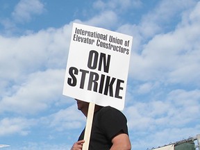 A striking member of the International Union of Elevator Constructors pickets the construction site of Windsor's Family Aquatic Complex on May 8, 2013. (Dan Janisse / The Windsor Star)