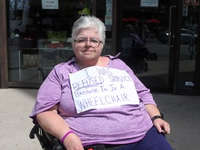 Jacqueline Coyne sits outside of Cose Belle Gifts and Unique Shop at 380 Ouellette Ave. Friday, May 3, 2013. Coyne says she was was refused service by the business owner because she uses a motorized wheelchair. (DYLAN KRISTY/The Windsor Star)