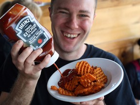 Gilligan's owner Chad Johnson is all smiles with new Heinz balsamic ketchup. (NICK BRANCACCIO / The Windsor Star)
