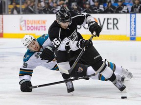 Los Angeles defenceman Slava Voynov, foreground, battles San Jose's Logan Couture during Game 7 of the Western Conference semifinals in Tuesday, May 28, 2013, in Los Angeles. (AP Photo/Mark J. Terrill)